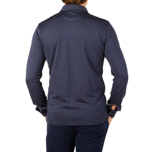 The back view of a man wearing a Fedeli Navy Blue Organic Cotton LS Polo Shirt.