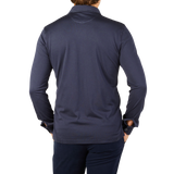 The back view of a man wearing a Fedeli Navy Blue Organic Cotton LS Polo Shirt.