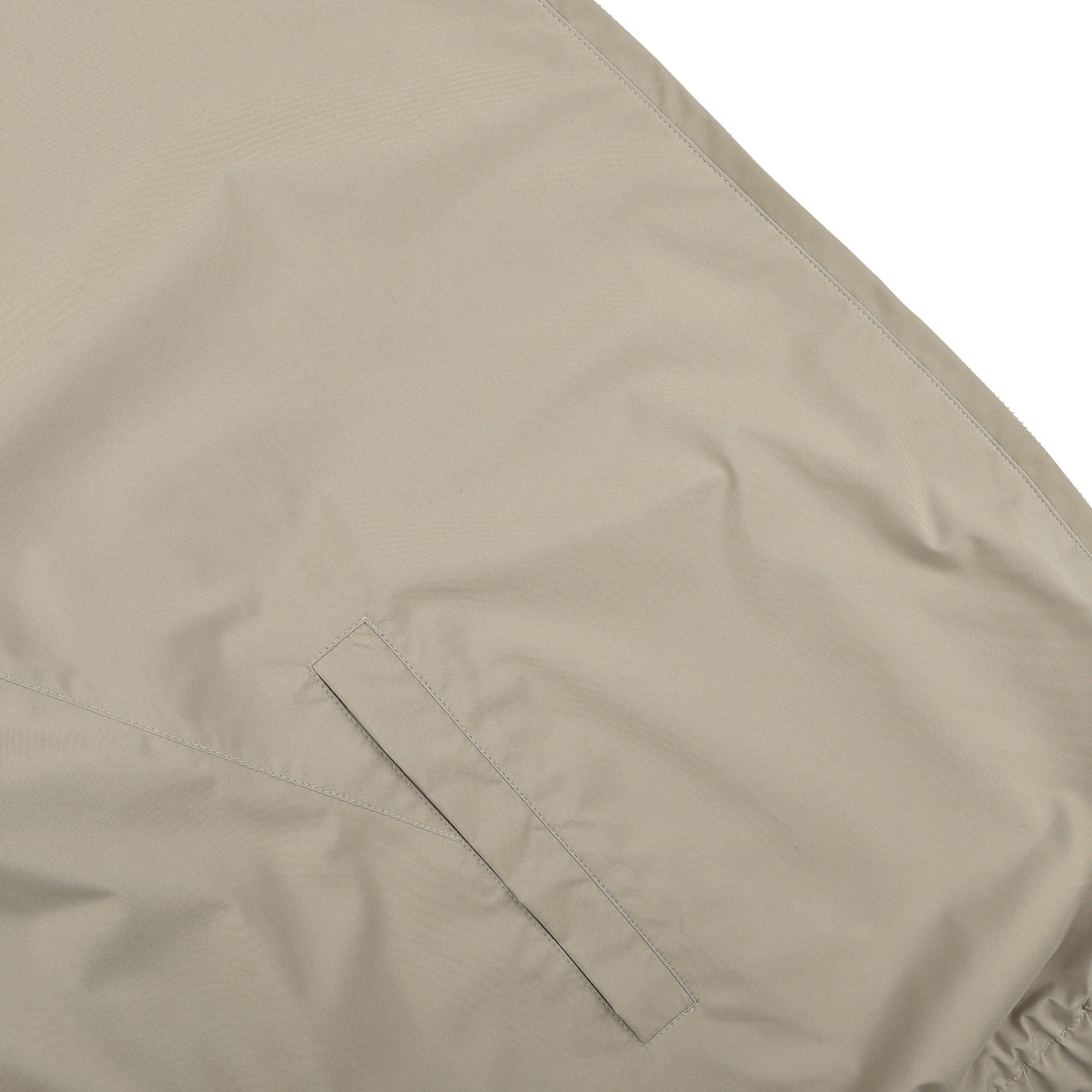 Close-up of a Fedeli Beige Nougat Nylon Reversible Blouson Jacket made from water-resistant nylon, highlighting visible stitching and a horizontal slit pocket.