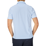 Man standing with his back to the camera wearing a Fedeli Blue Multi Striped Cotton Jersey Polo Shirt.