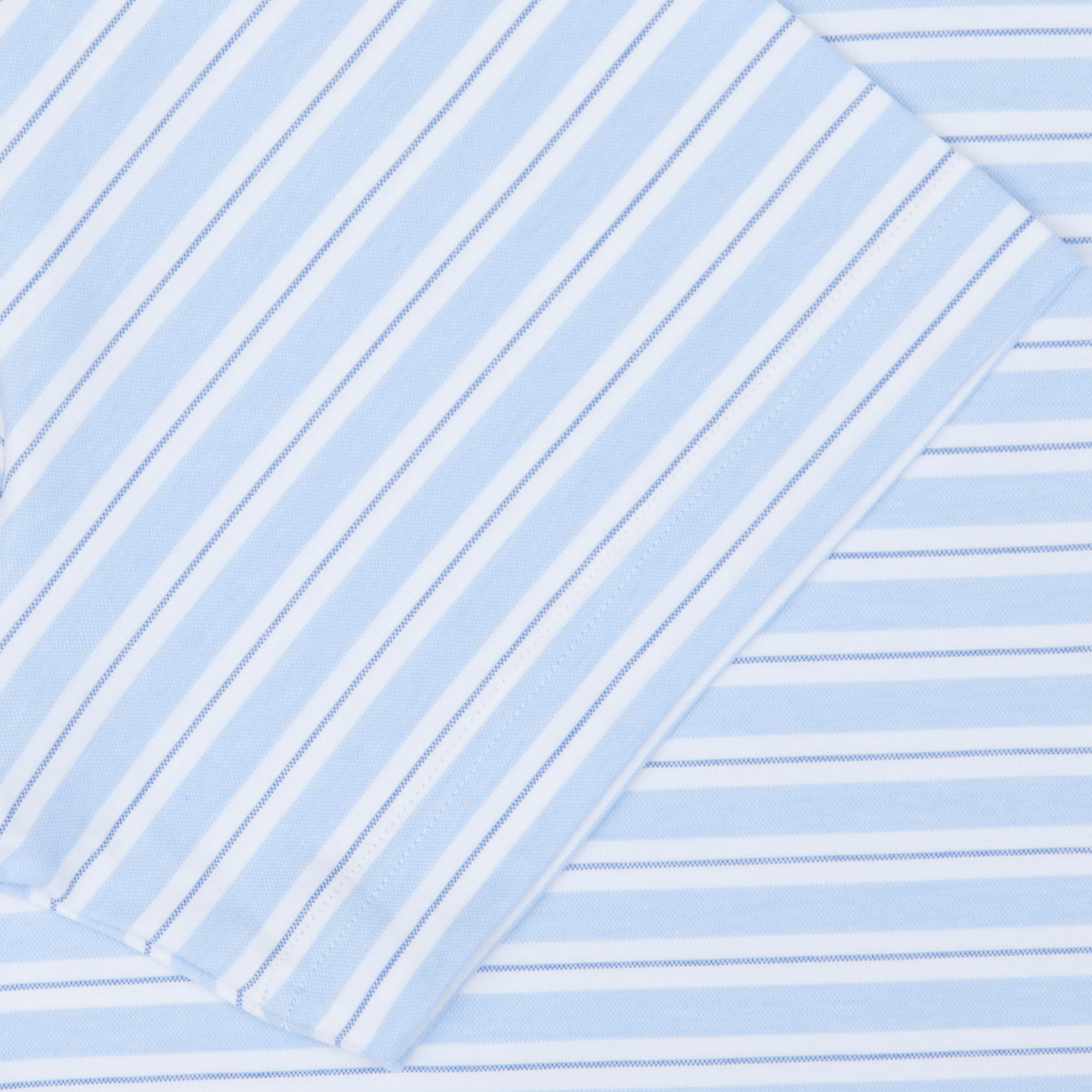 Blue and white striped Fedeli cotton-nylon blend fabric arranged diagonally with a folded edge visible.