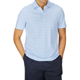 A person wearing a Fedeli blue multi striped cotton jersey polo shirt and dark trousers.