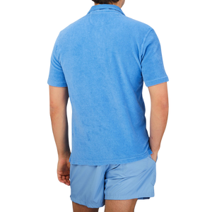 The back view of a man wearing a blue Fedeli Bright Blue Cotton Towelling Polo Shirt.