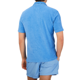The back view of a man wearing a blue Fedeli Bright Blue Cotton Towelling Polo Shirt.