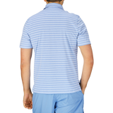 Man wearing a slim fit, blue and white striped contemporary summer Fedeli polo shirt, viewed from the back.
