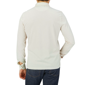 The back view of a man wearing a luxurious Cream Beige Organic Cotton LS Polo Shirt made by Fedeli.