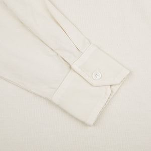 A close up of a Fedeli Cream Beige Organic Cotton LS Polo Shirt on a white surface.