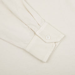 A close up of a Fedeli Cream Beige Organic Cotton LS Polo Shirt on a white surface.