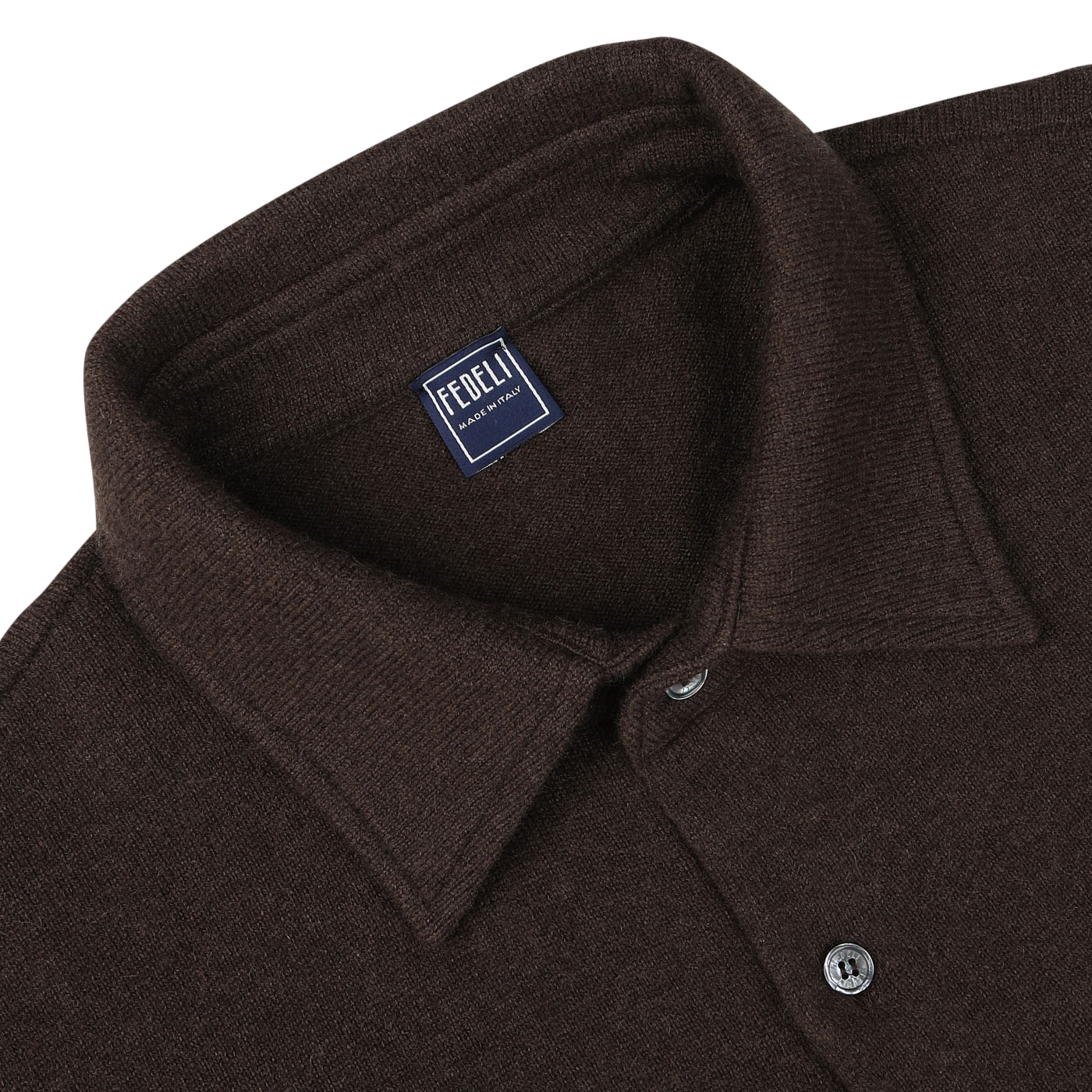 A close-up of a dark brown felted cashmere overshirt with a collar and buttons, featuring a label that reads "Fedeli, Made in Italy." This luxurious garment offers both style and comfort with its regular fit design.