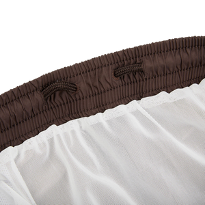 A close up of a Fedeli Dark Brown Microfiber Madeira Swim Shorts curtain.