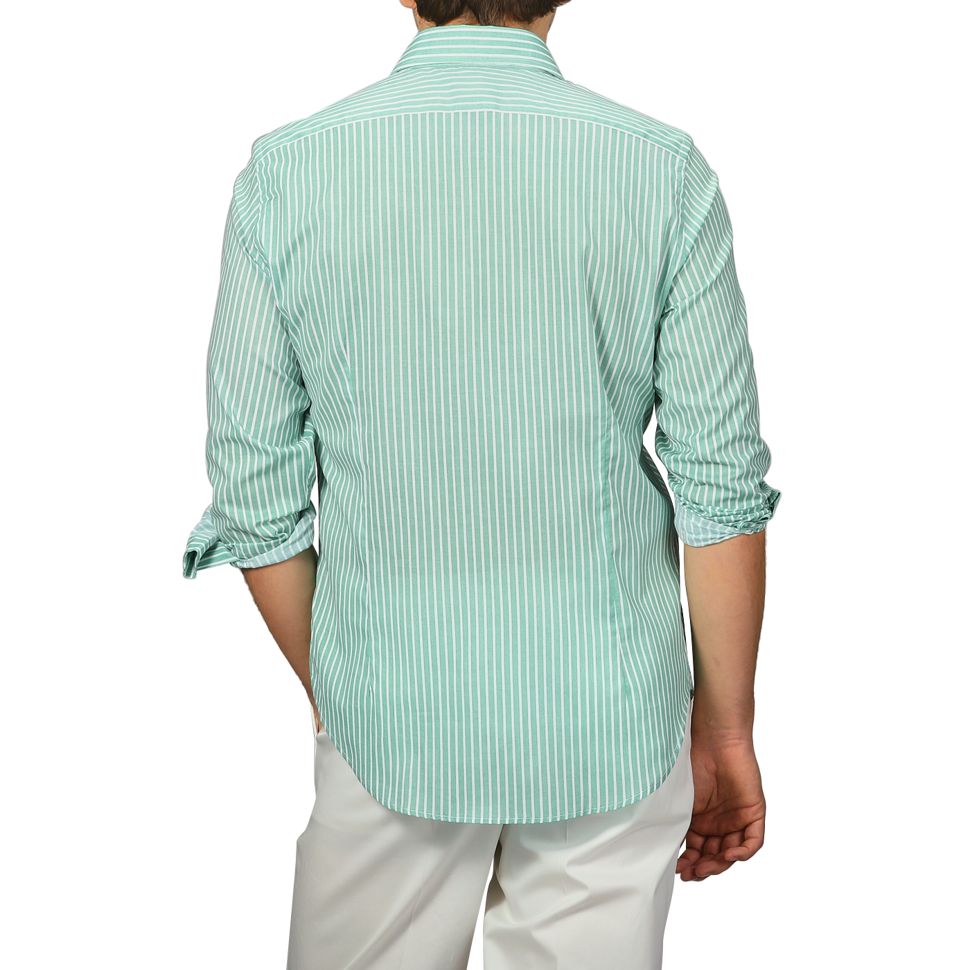 A person wearing a Fedeli slim fit Green White Striped Cotton Beach Shirt with rolled-up sleeves and white pants faces away from the camera.