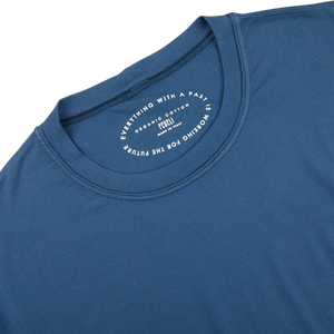 The back of a luxury Indigo Blue Organic Cotton T-Shirt by Fedeli with a white logo on it.