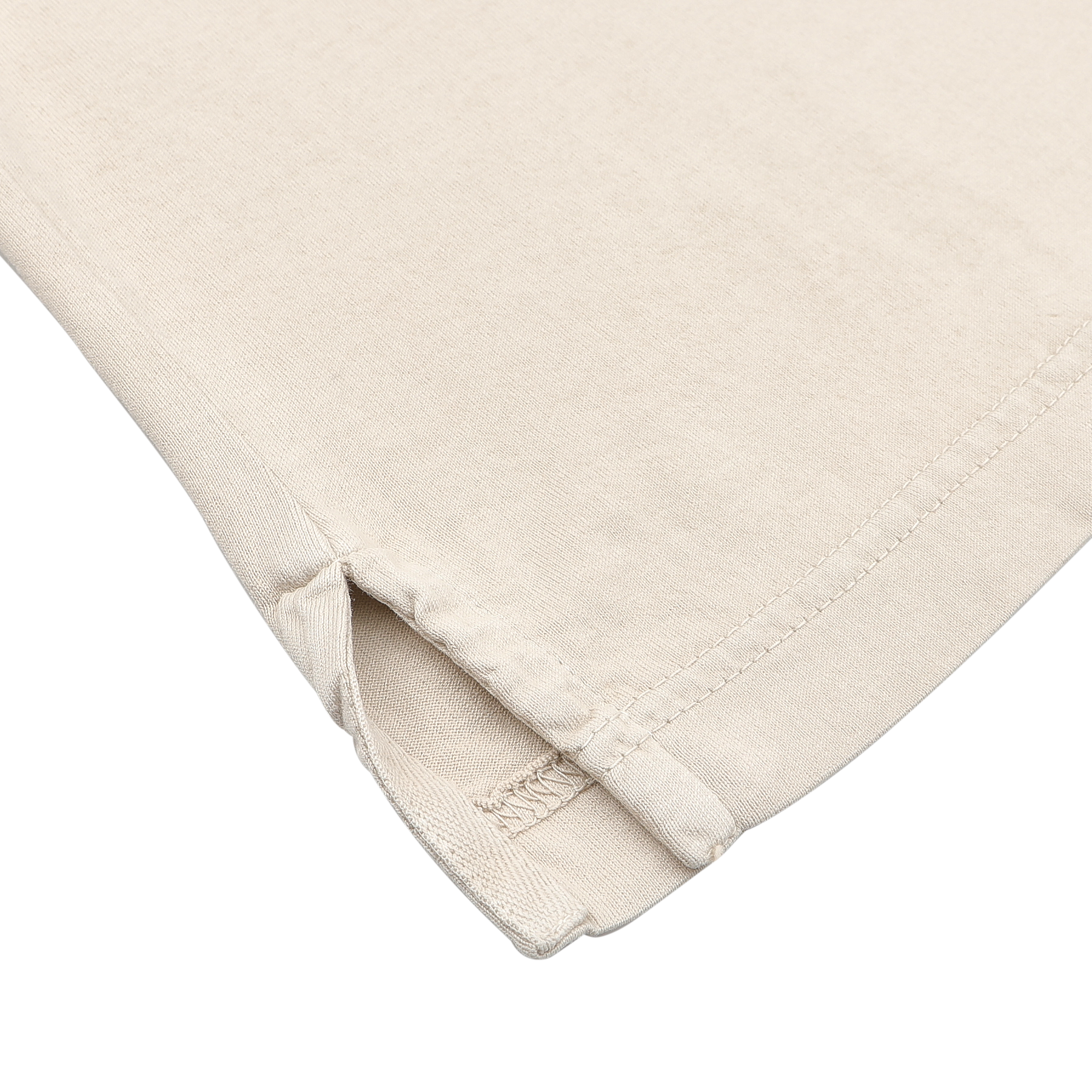 A close-up of the Light Beige Organic Cotton Capri Collar Polo Shirt by Fedeli highlights a corner with a side slit and reinforced stitching, exuding a casual summer vibe.