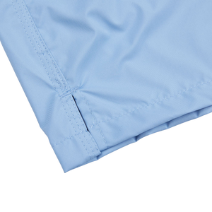 An up-close view of Fedeli Light Blue Microfiber Madeira Swim Shorts with a zipper.