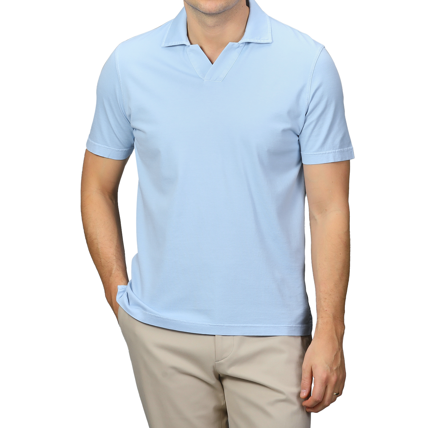 A person showcases a stylish look with Fedeli's Light Blue Organic Cotton Capri Collar Polo Shirt paired with beige pants, standing against a gray background with one hand in their pocket.