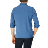 The back view of a man wearing a Fedeli Light Blue Organic Cotton LS Polo Shirt.