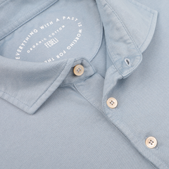 Close-up of a light blue polo shirt by Fedeli featuring "Everything with a past is working for the future" and "Organic Giza Cotton" elegantly printed on the collar—a perfect piece for those who appreciate luxury casual-wear.