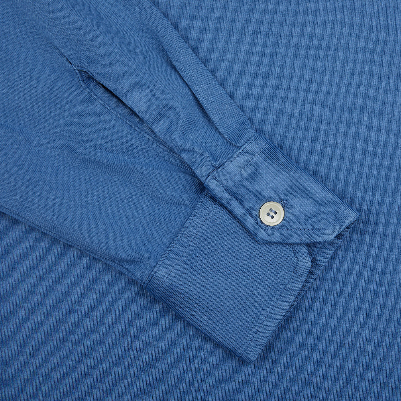 A close up of a Fedeli Light Blue Organic Cotton LS Polo Shirt with buttons.