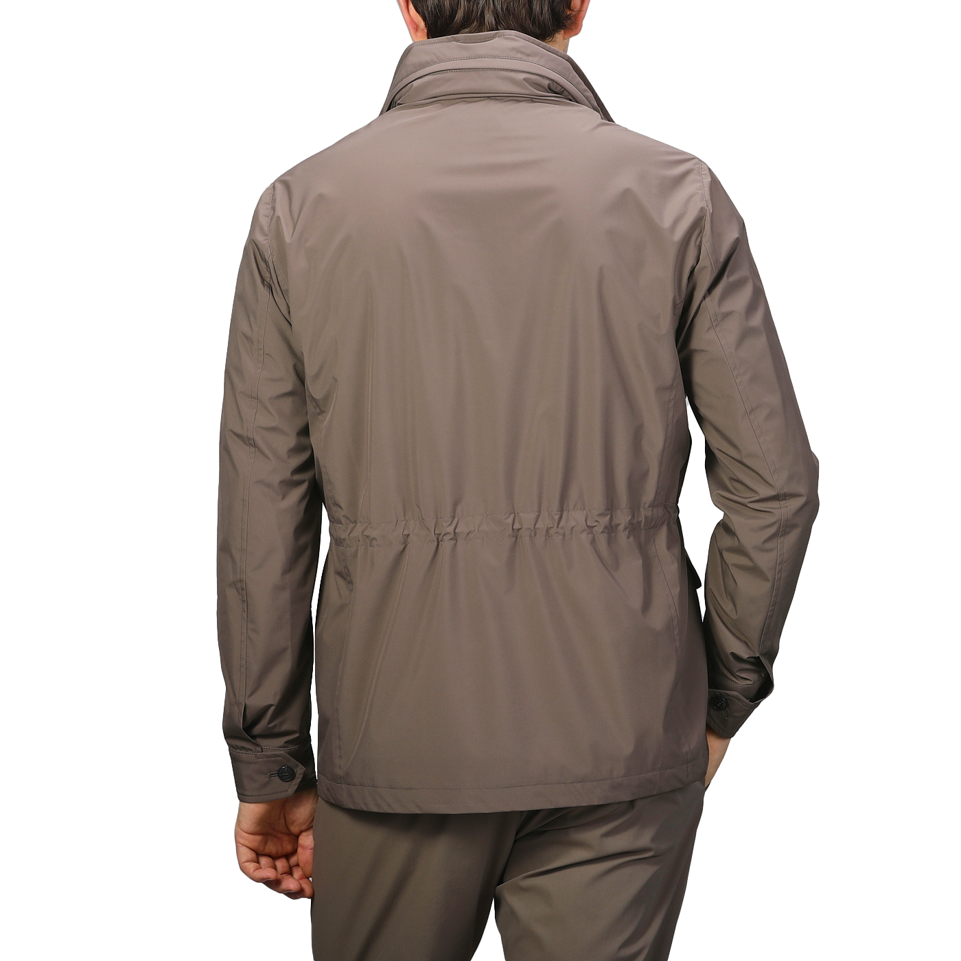 A person wearing a Fedeli Light Brown Nylon Rainproof Field Jacket and pants stands with their back to the camera against a light gray background.