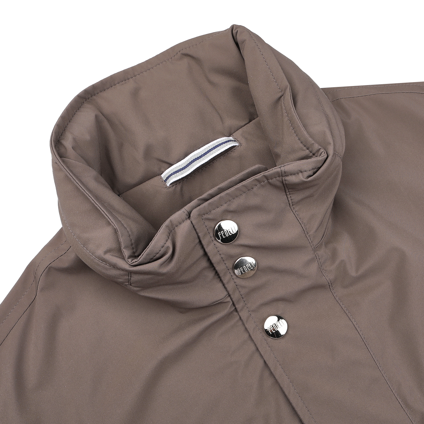 Close-up of a brown field jacket collar with metal buttons and a striped fabric tab inside. This Light Brown Nylon Rainproof Field Jacket, designed by Fedeli in a slim fit, is both wind and water-resistant.