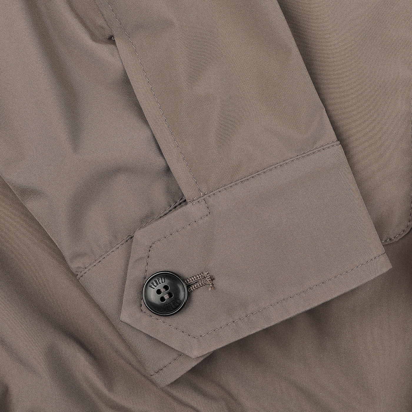 Close-up of Fedeli's Light Brown Nylon Rainproof Field Jacket, showcasing a buttoned cuff with detailed stitching.