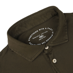 The Moss Green Organic Cotton LS Polo Shirt by Fedeli features a white inner collar with the text, "Everything with a past is working for a future." Made in Italy from Giza cotton, this shirt epitomizes luxury casual-wear.