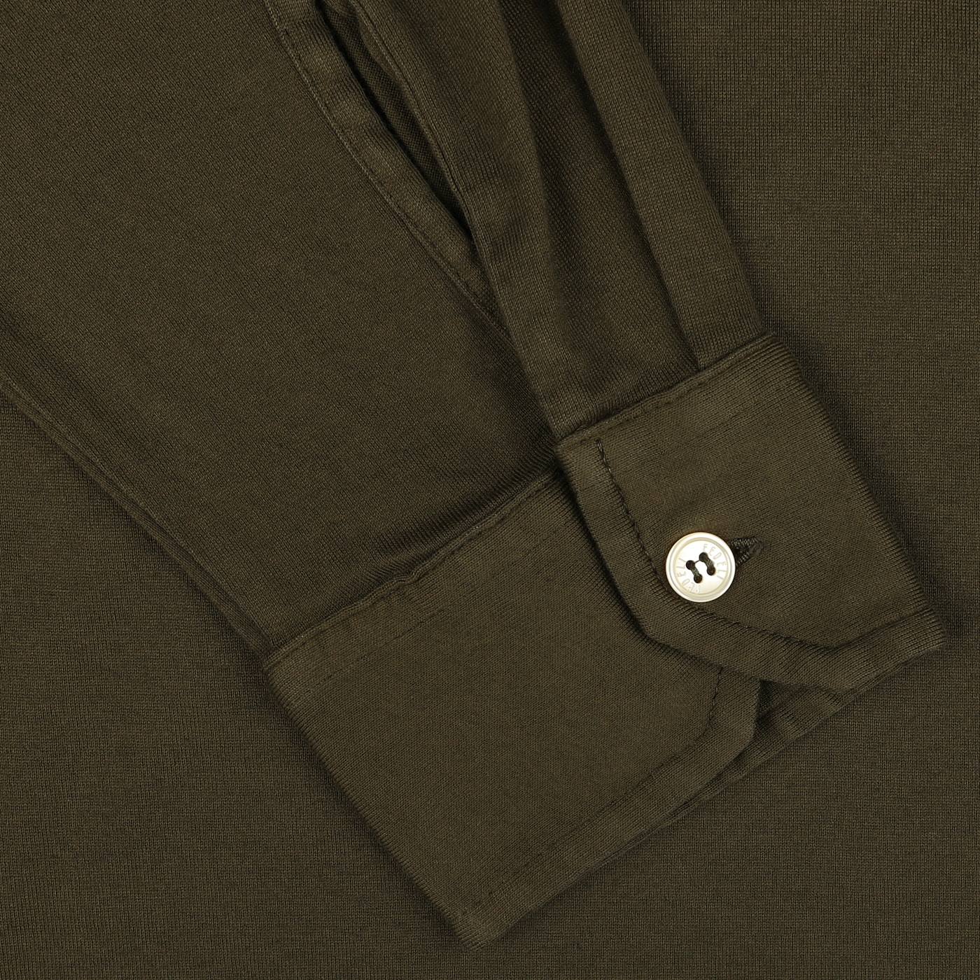 Close-up of a rolled-up Moss Green Organic Cotton LS Polo Shirt by Fedeli, displaying a buttoned cuff.