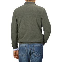 A person is shown from behind, wearing a Moss Green Wool Cashmere 1/4 Zip Sweater by Fedeli and blue jeans.