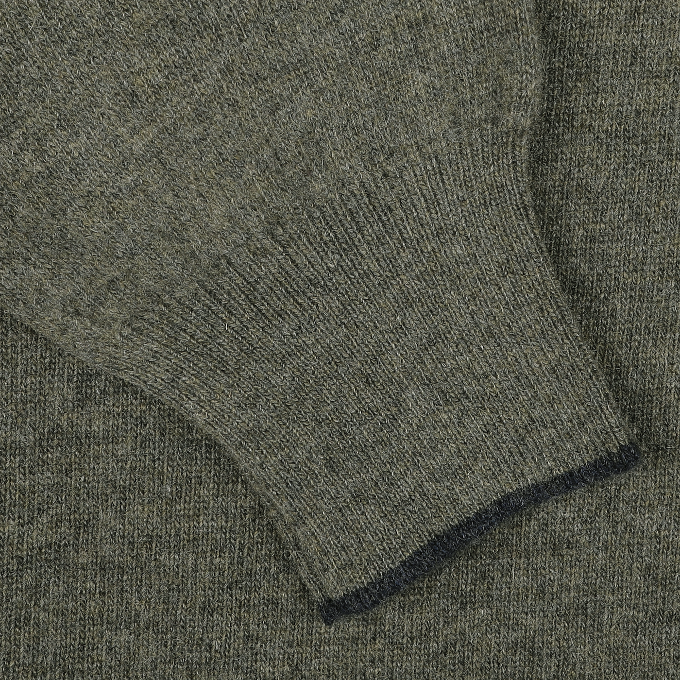 Close-up of a green knitted fabric sleeve showing the ribbed cuff detail of the Moss Green Wool Cashmere 1/4 Zip Sweater by Fedeli.