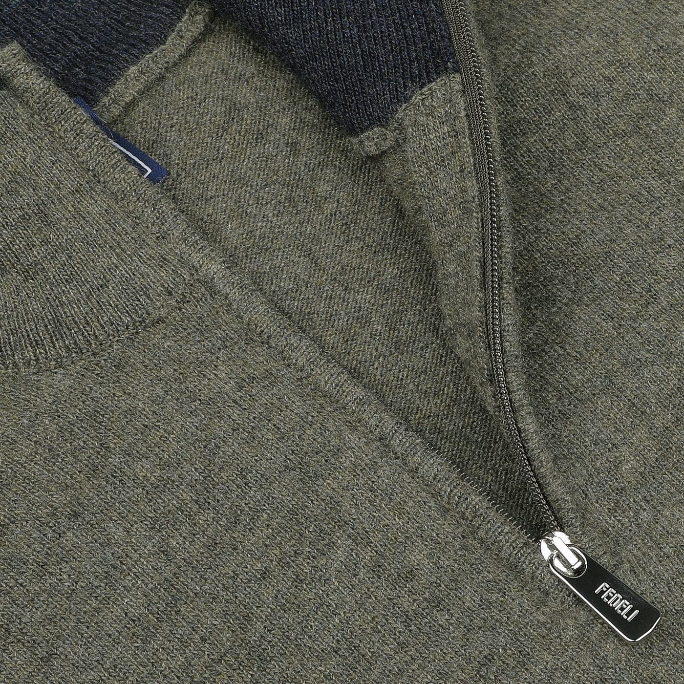 Close-up of a moss green wool-cashmere blend zip-up sweater, showcasing the zipper with a "Fedeli" branded pull tab and a portion of the fabric texture.