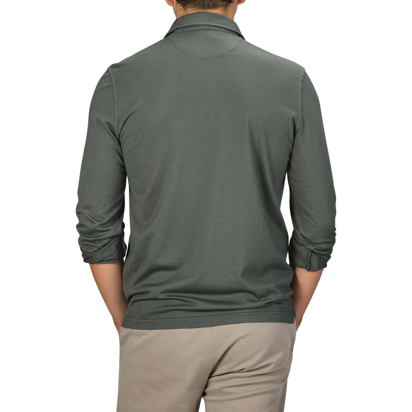 A person wearing the Fedeli Muted Green Organic Cotton LS Polo Shirt paired with beige pants, viewed from the back against a plain background.