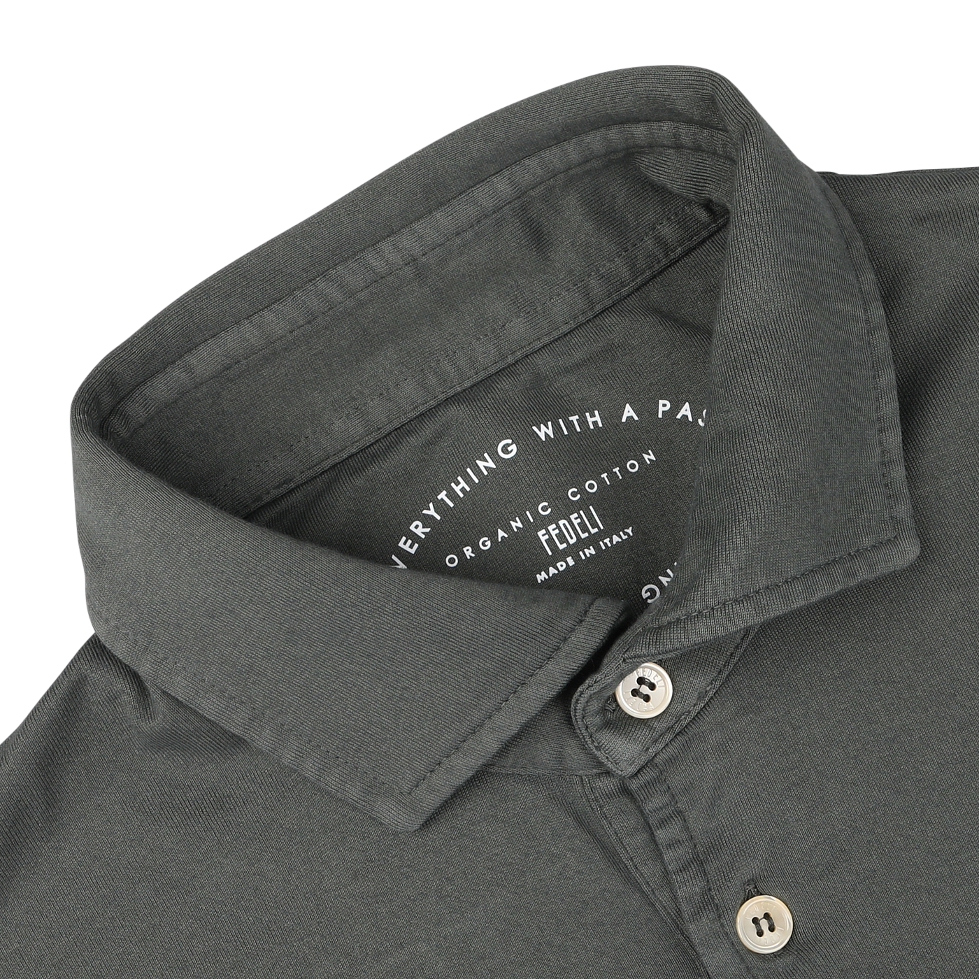 Close-up of a muted green collared shirt with "Everything With a Passion" and "Fedeli Made in Italy" text on the inner collar, seamlessly blending luxury casual-wear with the elegance of organic Giza cotton.