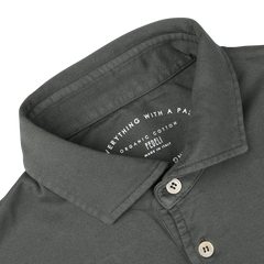 Close-up of a muted green collared shirt with "Everything With a Passion" and "Fedeli Made in Italy" text on the inner collar, seamlessly blending luxury casual-wear with the elegance of organic Giza cotton.