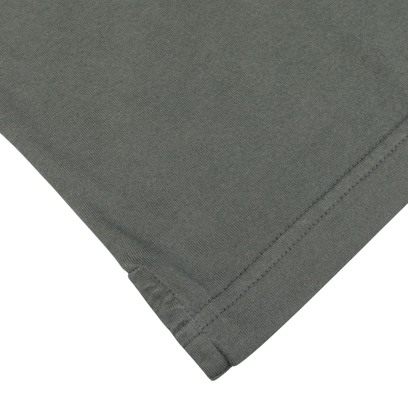 Close-up of the hem of a muted green fabric, possibly a long-sleeve polo shirt or similar garment, against a white background. Made from organic Giza cotton, the stitching detail is visible, capturing the essence of luxury casual-wear by Fedeli.