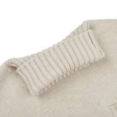 Experience the elegance of Fedeli's Natural Beige Wool Cashmere Rollneck, a wool-cashmere masterpiece featuring a stylish roll neck in close-up view.