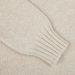 A close-up of the Fedeli Natural Beige Wool Cashmere Rollneck features a ribbed cuff on its sleeve.