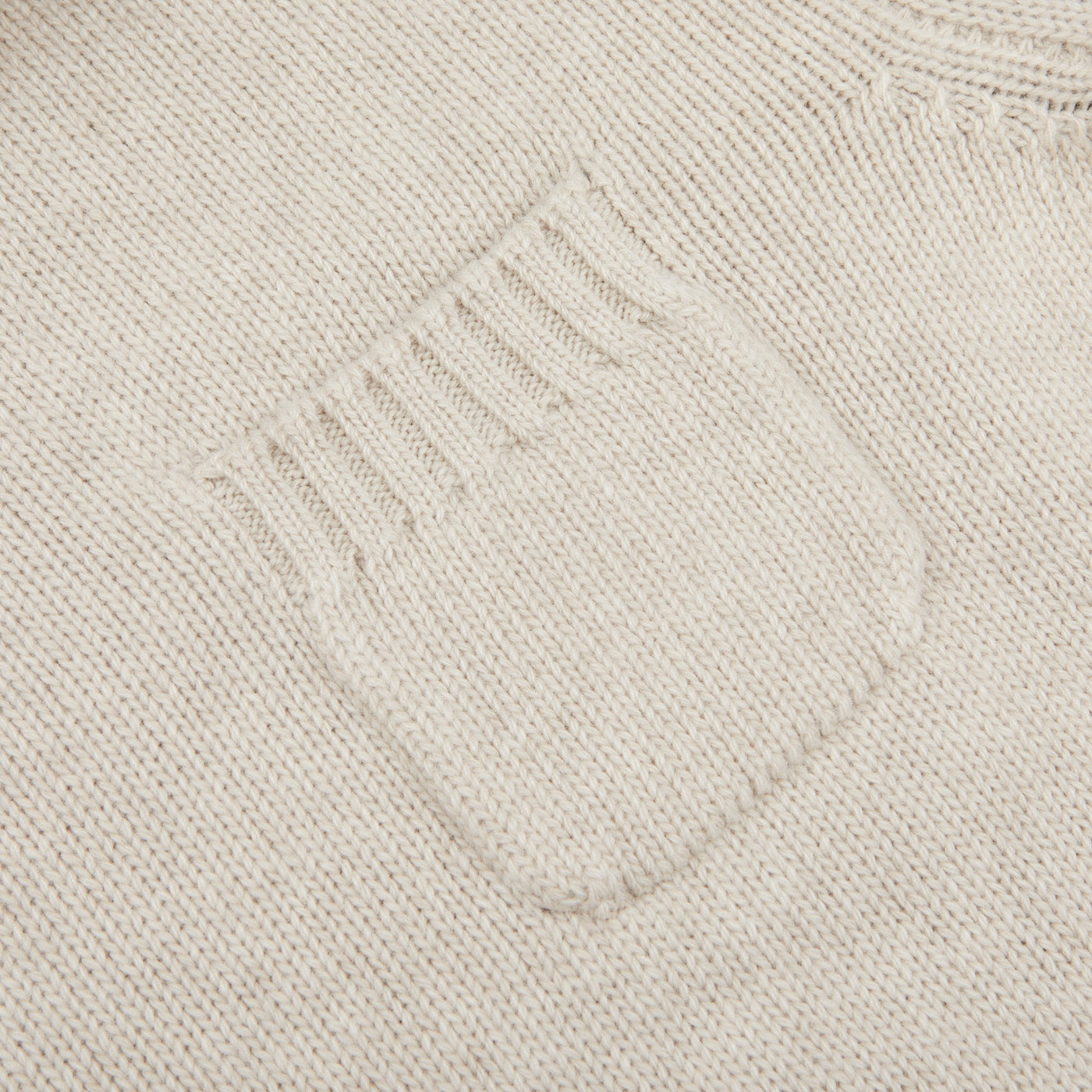 A close-up of the Fedeli Natural Beige Wool Cashmere Rollneck highlights its Italian-made elegance, featuring a small rib-detailed square pocket that exemplifies refined craftsmanship.