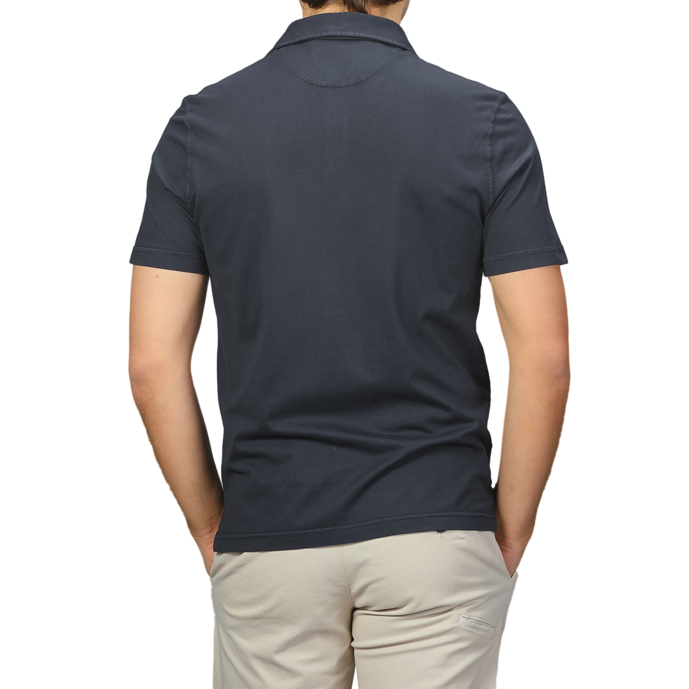 A person in a Navy Blue Organic Cotton Polo Shirt by Fedeli and light pants is shown from the back, standing against a neutral background.