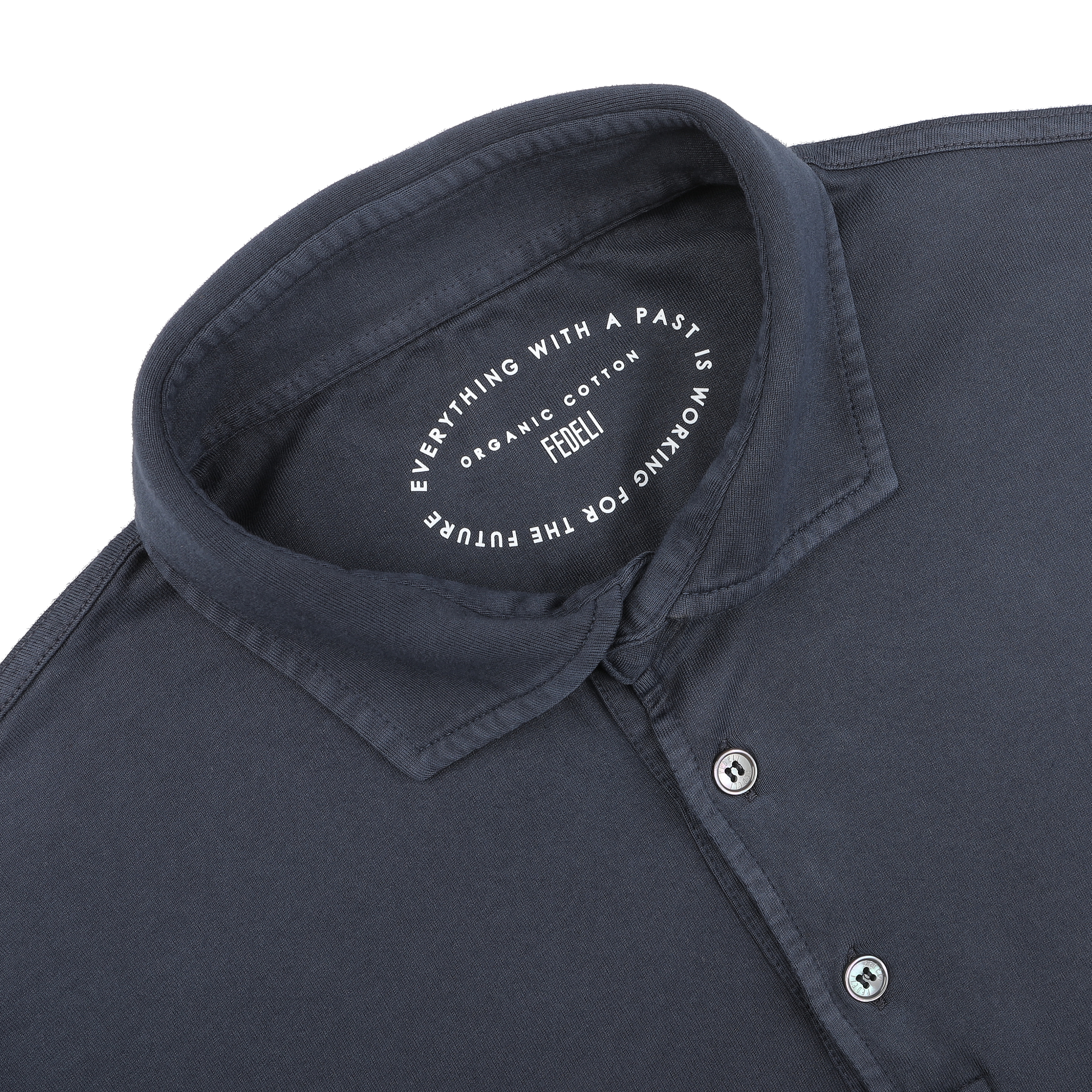 A navy blue polo shirt by Fedeli, made from organic cotton, features a white inner label reading "Everything with a past is working for the future. Crafted from organic Giza cotton. Feel it.