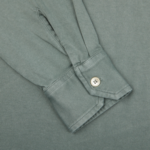 A close up of a luxury Olive Green LS Polo shirt with buttons on the cuff, made from organic Giza cotton by Fedeli.
