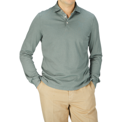 A man wearing a luxury Fedeli Olive Green Organic Cotton LS Polo Shirt and tan pants.