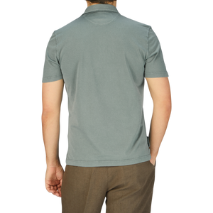 The back view of a man wearing a Fedeli Olive Green Organic Cotton Polo Shirt.