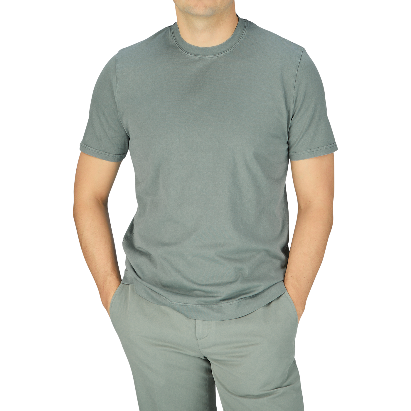 A man wearing a luxury Fedeli Olive Green Organic Cotton T-shirt and gray pants.