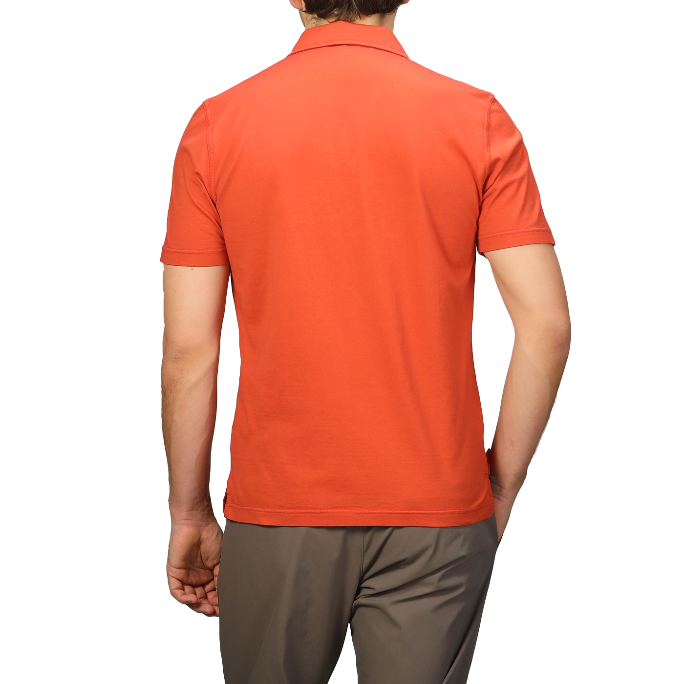 Seen from behind, a person wears an Orange Organic Cotton Capri Collar Polo Shirt by Fedeli and brown pants, epitomizing luxury casualwear.