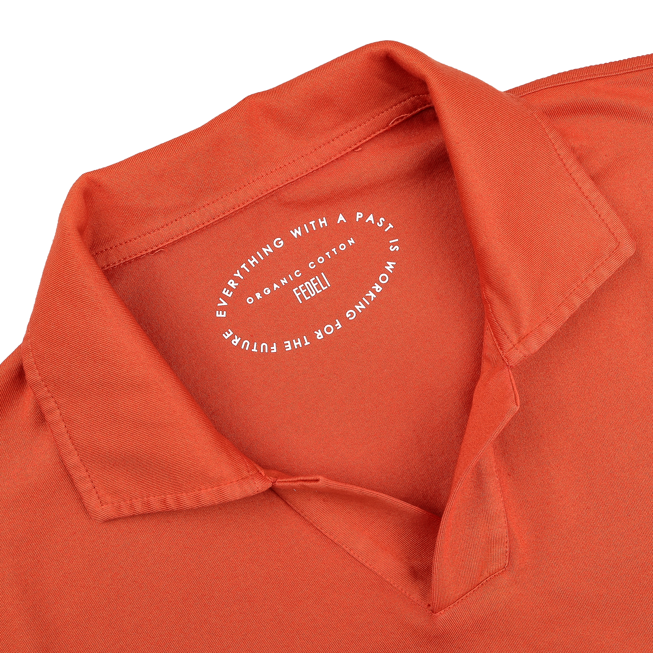 A close-up of the Fedeli Orange Organic Cotton Capri Collar Polo Shirt showcases its luxury casual-wear essence, with a printed circular label inside the collar.