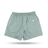A pair of Sage Green Madeira Microfiber swim shorts by Fedeli in light teal quick-dry microfiber, featuring an elastic waistband, a white embroidered logo on the left leg, and a patch pocket with a label on.