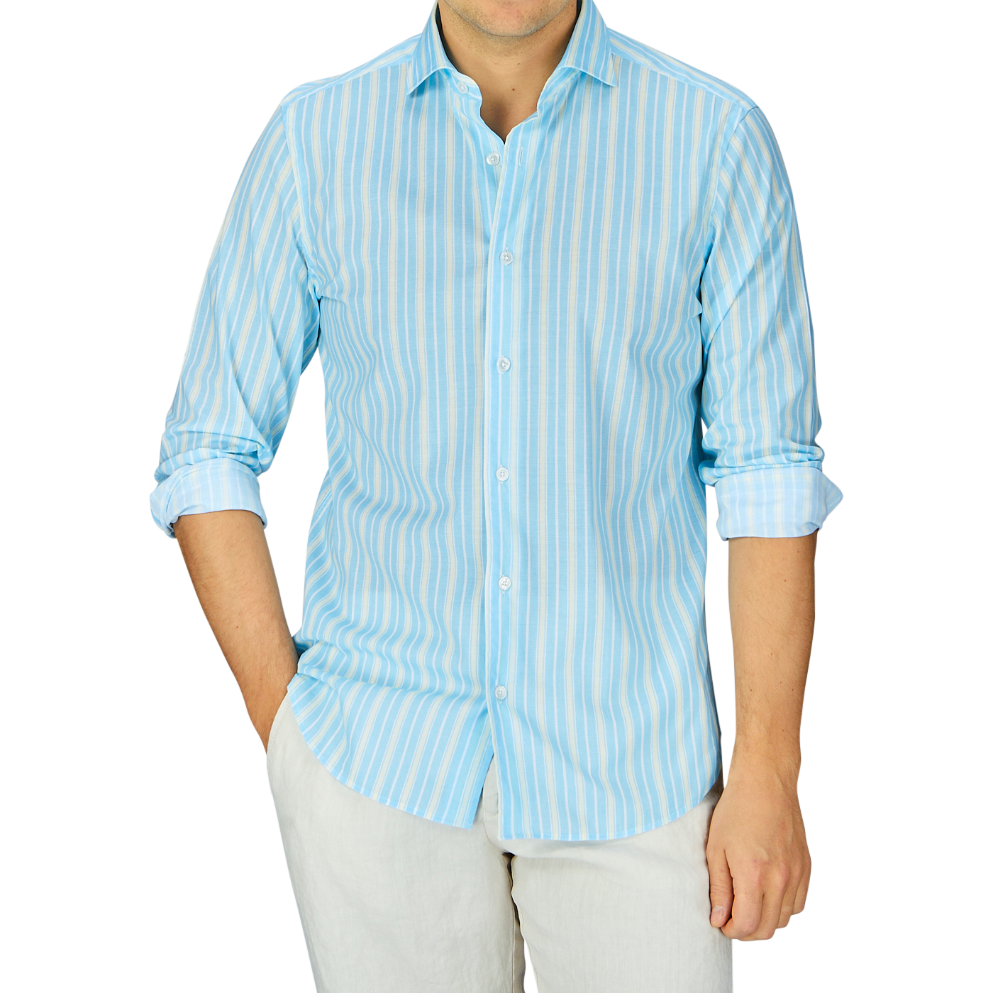 Man wearing a Fedeli Sky Blue Yellow Striped Cotton Beach Shirt, with blue and white stripes and light-colored pants against a gray background.