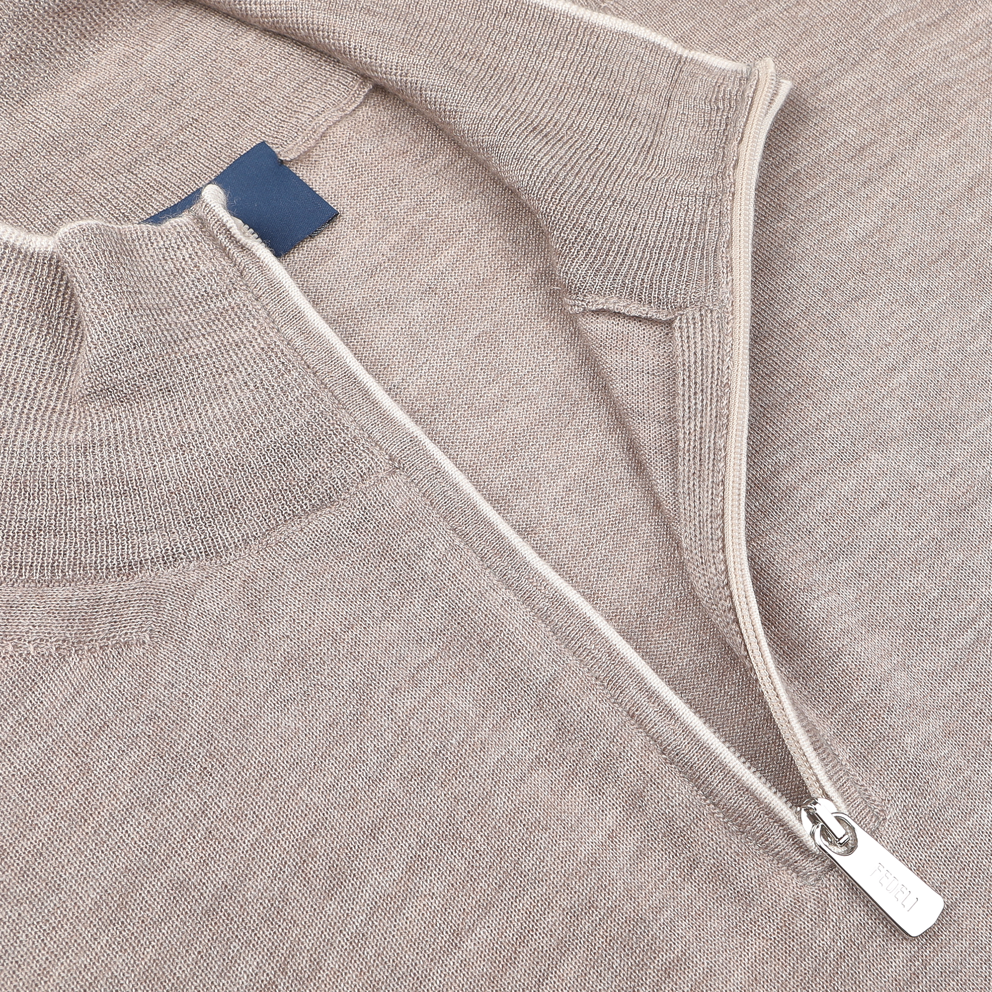 Close-up of the Fedeli Taupe Beige Cashmere Silk 1/4 Zip Sweater, highlighting its intricate texture and stitching details, featuring a luxurious cashmere-silk blend fabric with a half-zipper and collar.