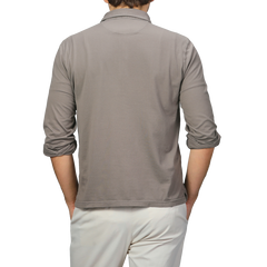 A person is shown from the back wearing a Taupe Beige Organic Cotton LS Polo Shirt by Fedeli and beige pants.