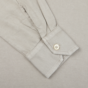 A close up of a Fedeli Taupe Beige Organic Cotton LS Polo Shirt with buttons.